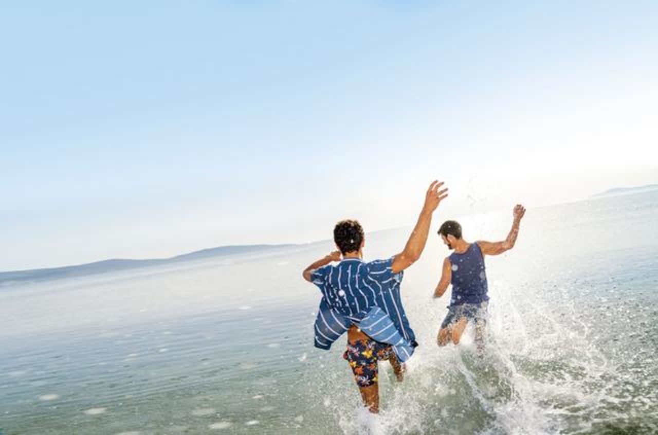 couple splashing in the water having fun